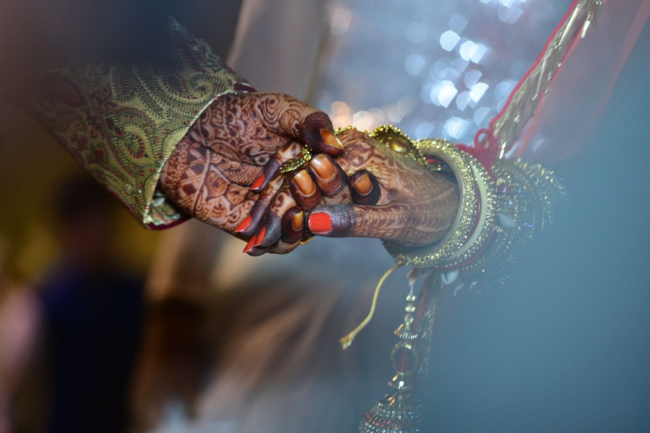 services-01 A beautiful capture of mehndi-decorated hands symbolizing love and tradition in a wedding ceremony.
